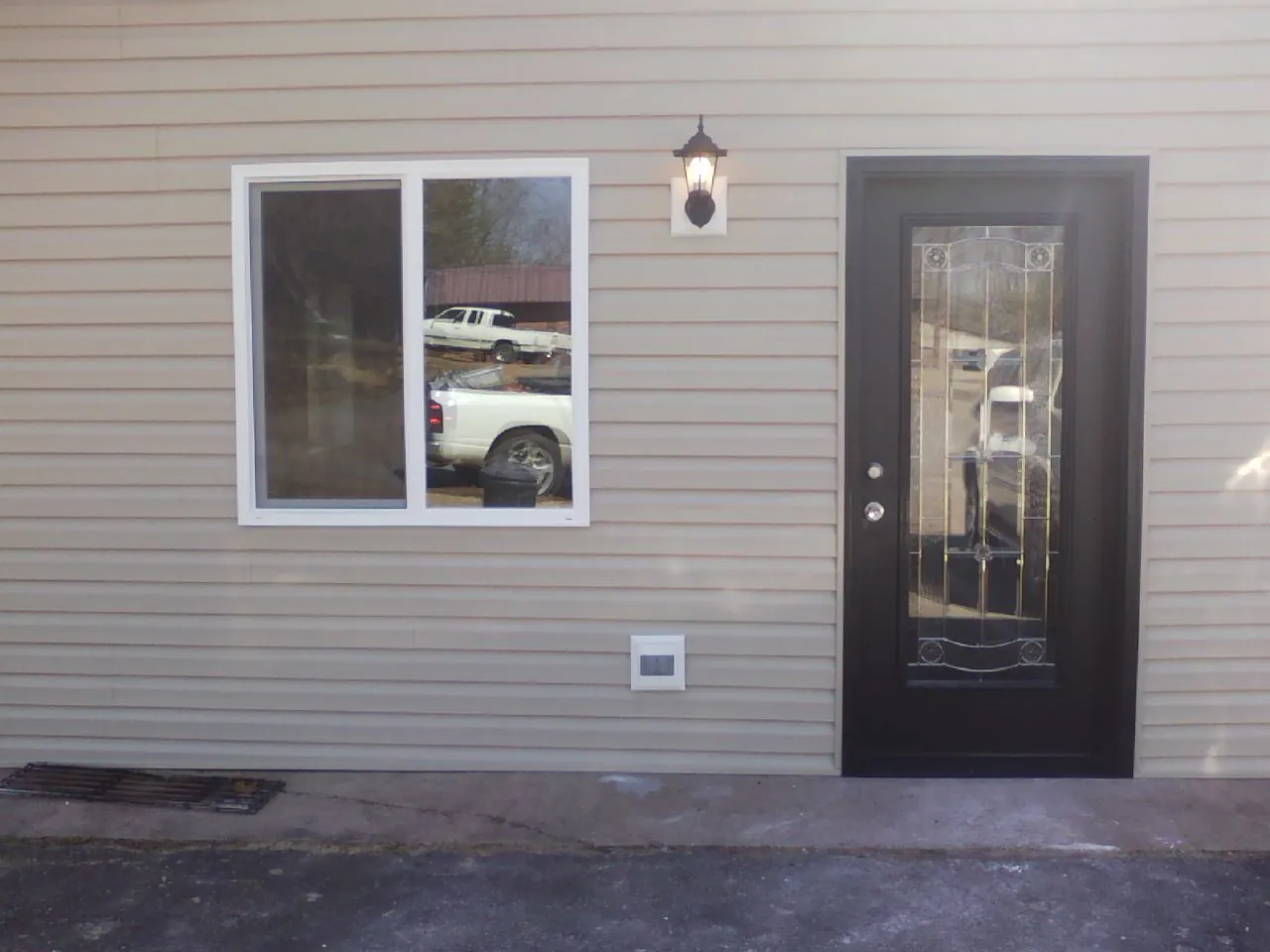 New siding, window and entry door on the side of an addition in Danville